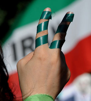 Iranian Protesters Hold Up Green Flags and Ribbons