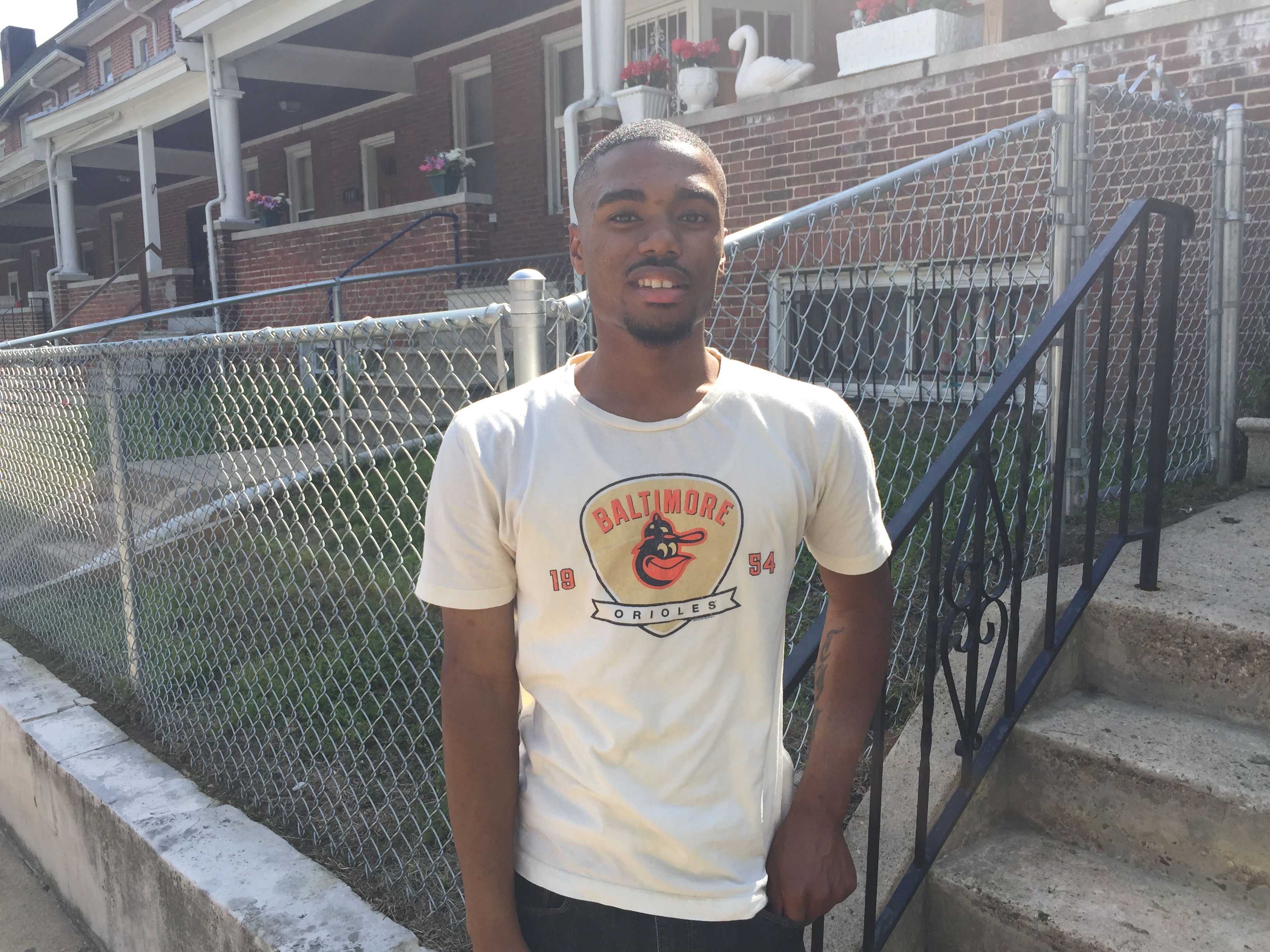 Tom Scott, standing in his West Baltimore neighborhood, is a community college student  who aspires to be a physical education teacher. (Photo: Josh Siegel/The Daily Signal) 