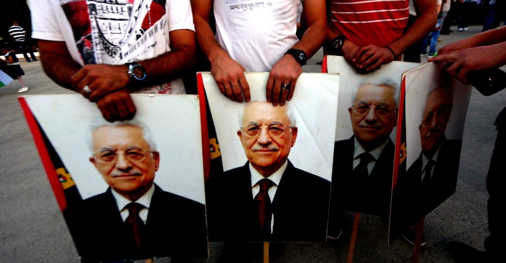 Palestinian hold pictures of president Mahmoud Abbas as they greet him upon his arrival from New York on October 2, 2015 where he attended a ceremony to mark the raising of the Palestinian flag at the United Nations headquarters. (Photo: Shadi Hatem/ZUMA Press/Newscom/Edited:Daily Signal)