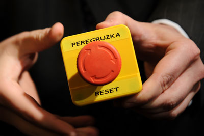 An assistant shows the block with a red button marked reset in English and overload in Russian that US Secretary of State Hillary Clinton handed to Russian Foreign Minister Sergei Lavrov during a meeting on March 6, 2009 in Geneva.