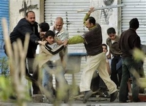 Egyptian Christian being beaten by Muslims