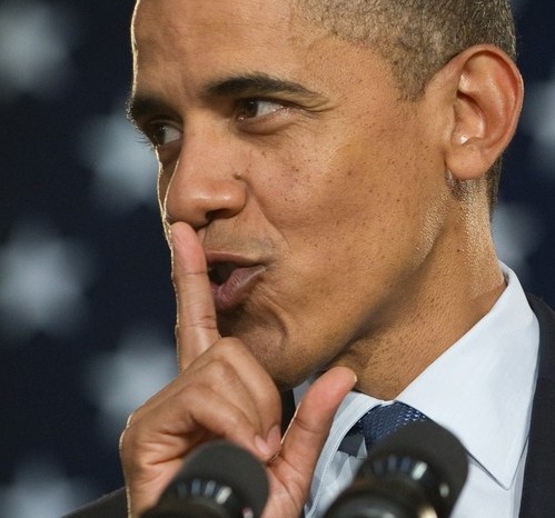 US President Barack Obama gestures for the crowd to keep quiet about his visit to the O&H Danish Bakery to buy kringle pastries so that First Lady Michelle Obama wouldn't find out about the visit, during a town hall event on the economy at Racine Memorial Hall in Racine, Wisconsin, June 30, 2010. AFP PHOTO / Saul LOEB (Photo credit should read SAUL LOEB/AFP/Getty Images)