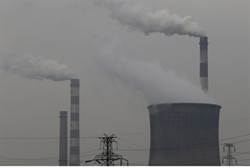 Smoking chimneys and cooling tower of a coal-burning power plant