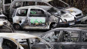 Notice the Arabic Graffiti painted on one of the burned cars.