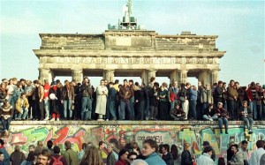 The Fall of the Berlin Wall. People on top of the Berlin Wall in front of the Brandenburg Gate in 1989