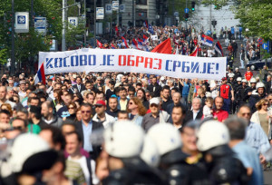 Protesters hold banners against the the EU-brokered Kosovo accord and call for a referendum on the deal as they march in Belgrade April 22, 2013