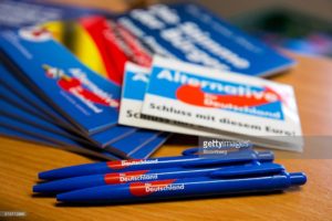 The Alternative for Germany (AfD) logo sits on pens as election campaign leaflets sit on display inside the party's campaign office in Magdeburg, Saxony-Anhalt state, Germany, on Monday, Feb. 29, 2016. While Chancellor Angela Merkel's Christian Democratic Union (CDU) has a chance to win the contests in Baden-Wuerttemberg, Rhineland-Palatinate and Saxony-Anhalt, a strong showing by the anti-immigrant Alternative for Germany party would risk increasing opposition to her open-door policy within her party. Photographer: Krisztian Bocsi/Bloomberg